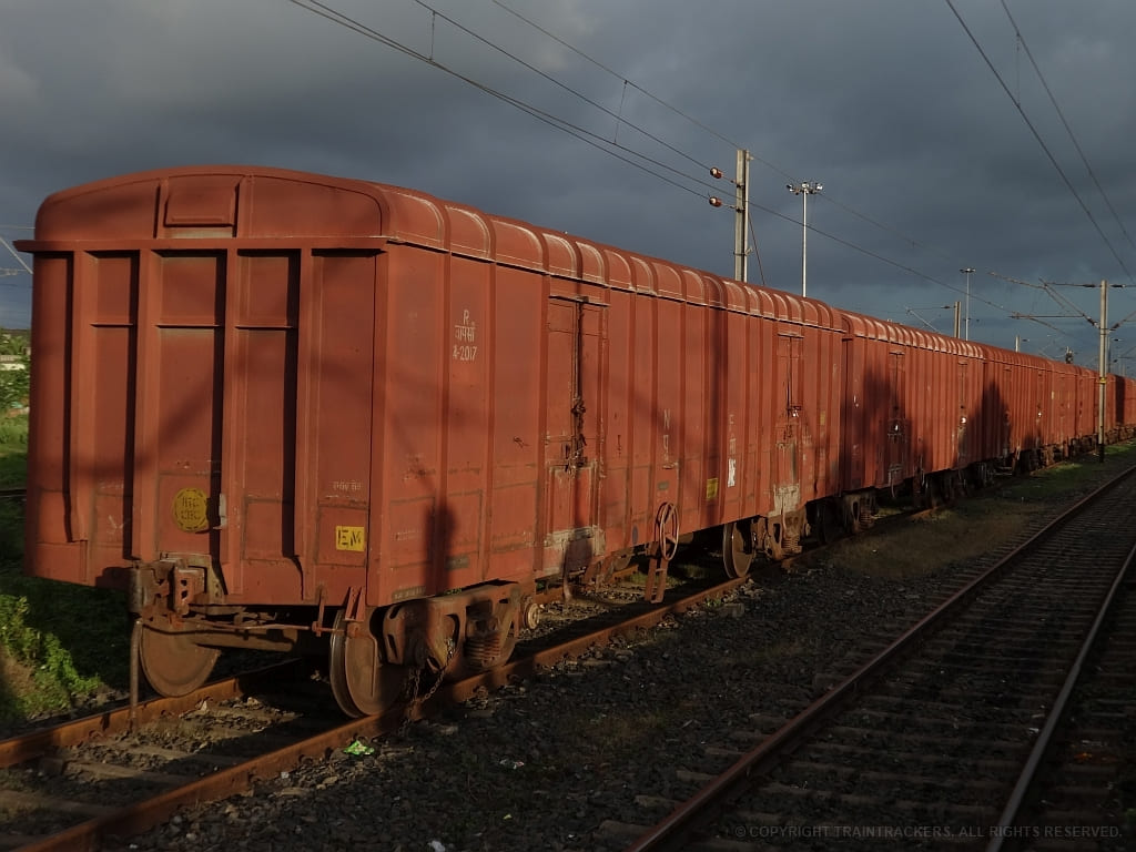 Indian Railways BCNA covered freight wagons transporting cement and bagged cargo on railway track