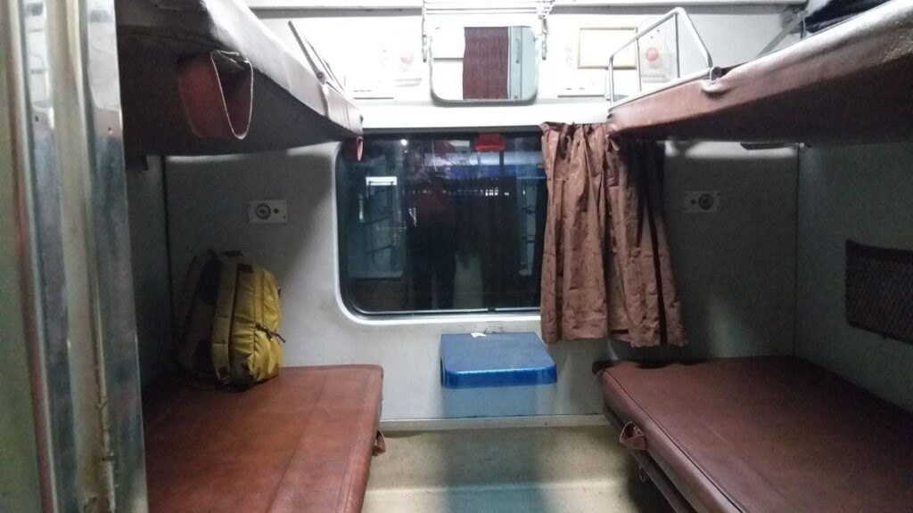 Indian Railways sleeper coach interior with berths and window seating