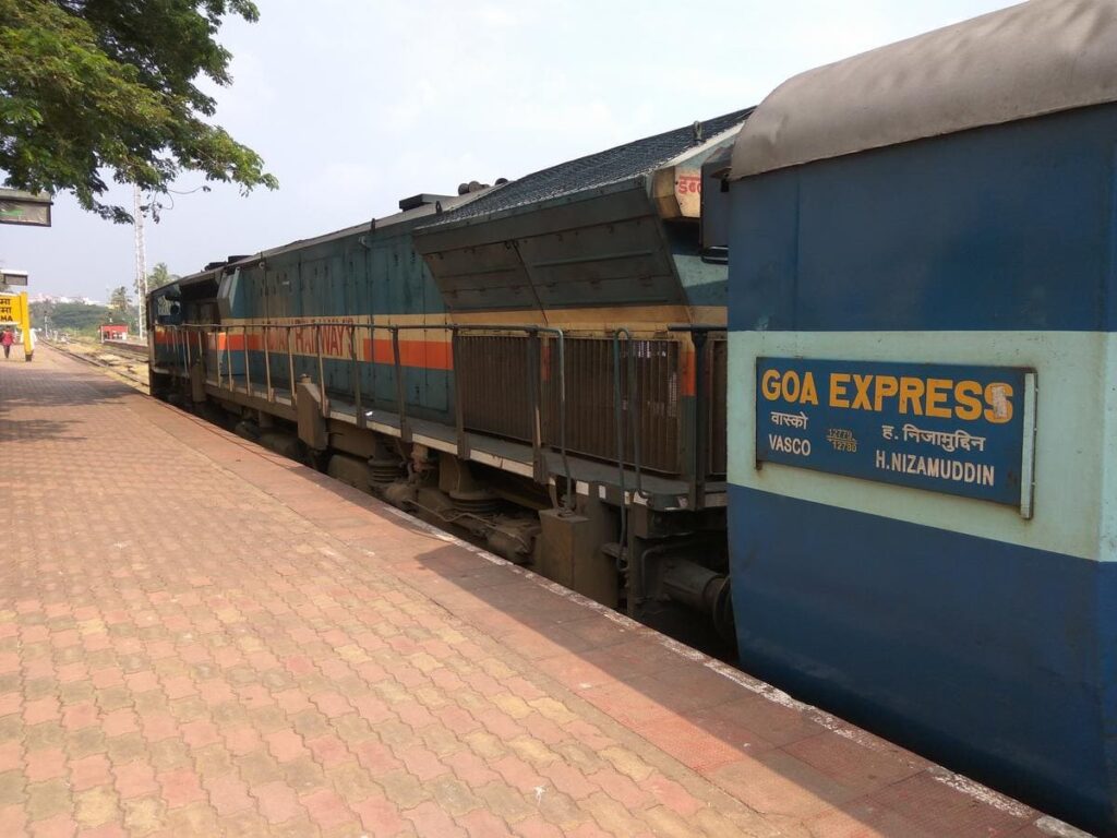 Goa Express train coach with route board Vasco to Hazrat Nizamuddin at railway platform
