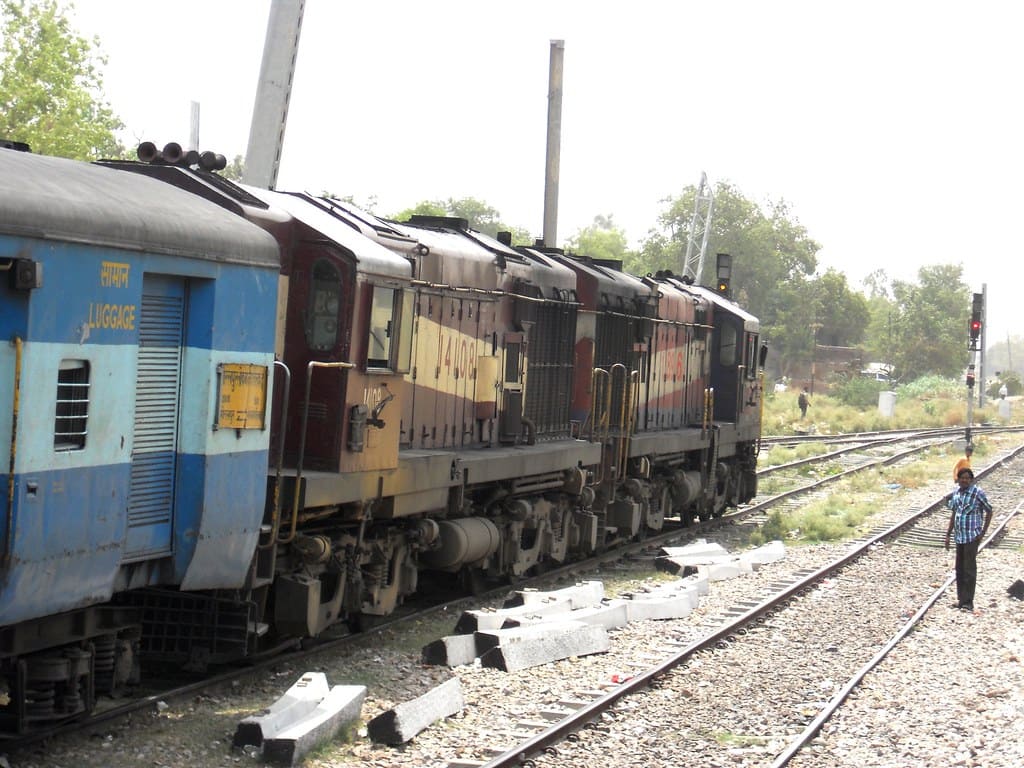 Indian Railways diesel locomotive with passenger coaches on track representing long distance high-demand train travel