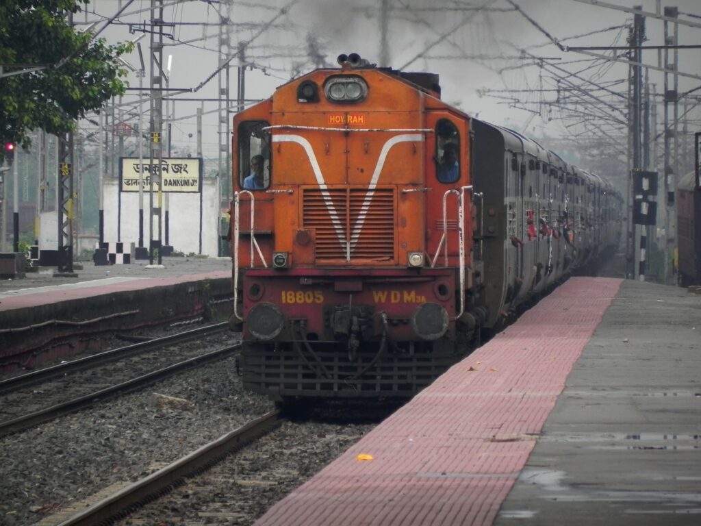 Indian Railways diesel locomotive WDM3A hauling passenger train at Dankuni Junction platform
