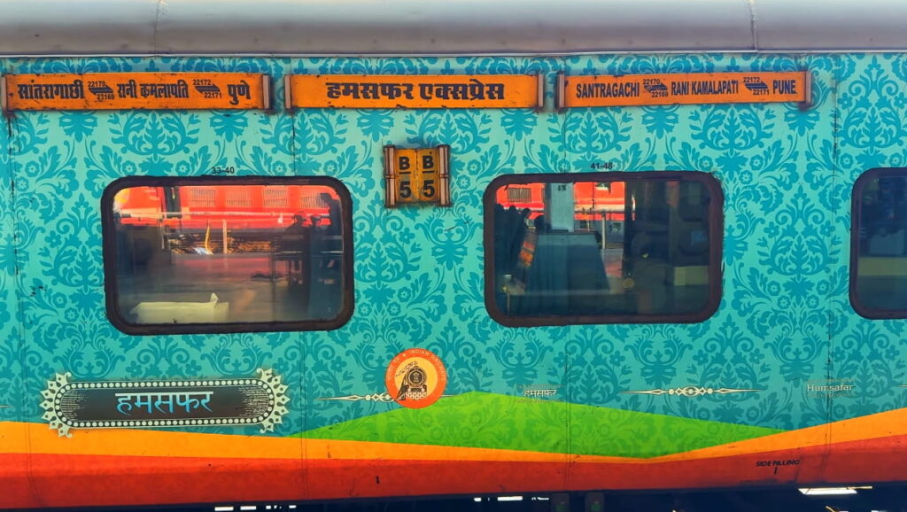Humsafar Express train coach with decorative exterior design at Indian railway station