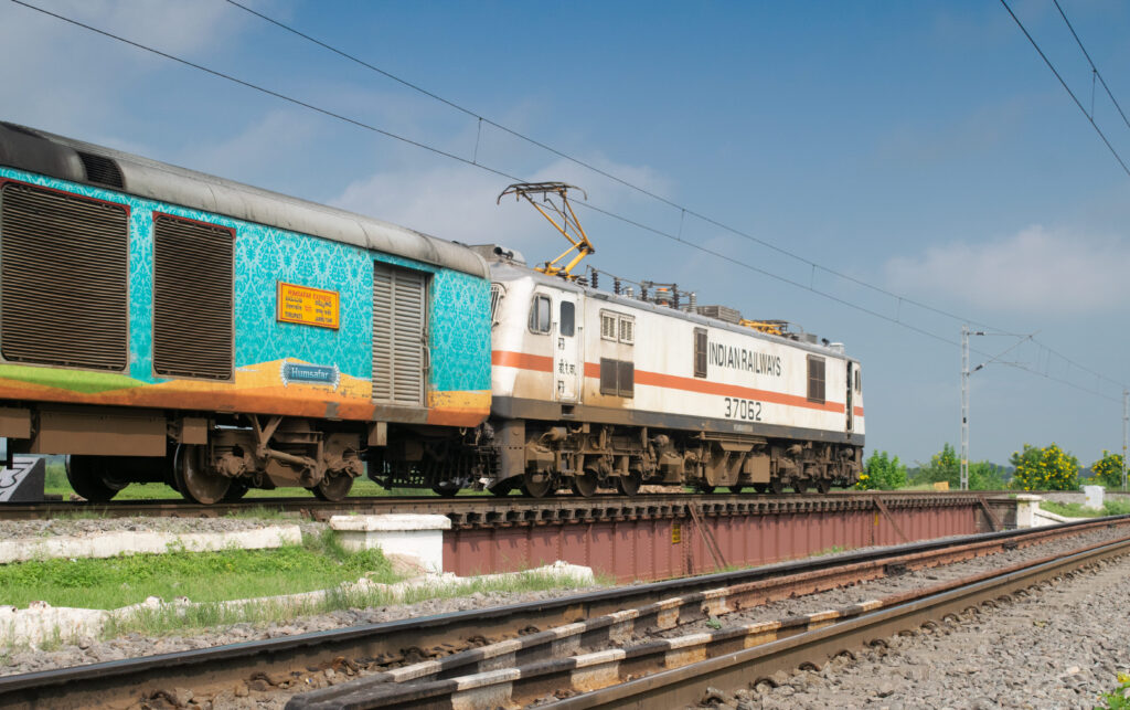 Indian Railways electric locomotive pulling Humsafar Express coach on track