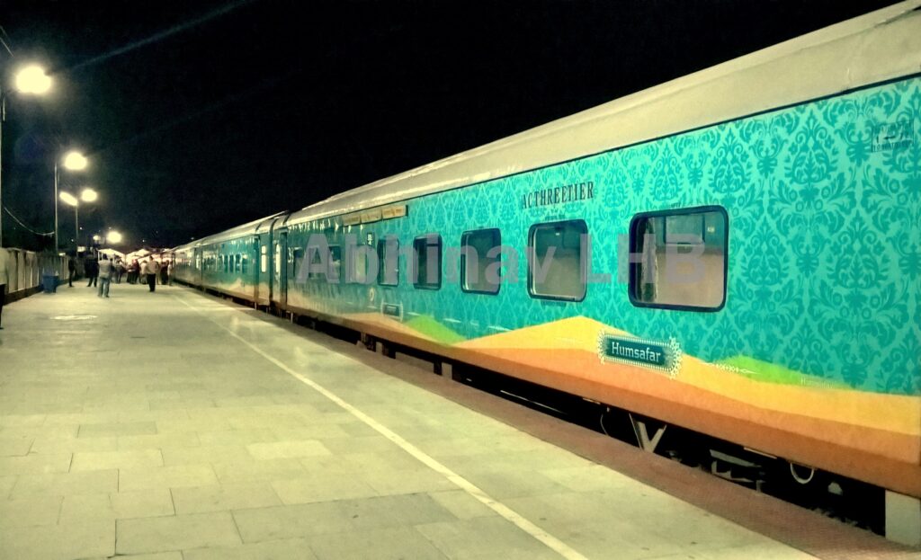 Humsafar Express train at night on railway platform showcasing modern AC 3 tier Indian Railways coach