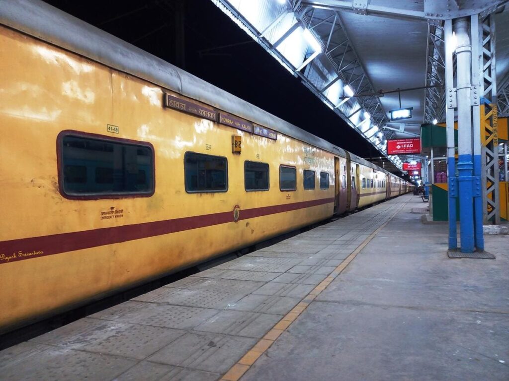 old Indian train coach standing at railway platform at night showcasing classic Indian Railways design