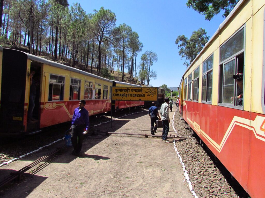 Kalka Shimla toy train at Kumarhatti Dagshai station in Himachal Pradesh surrounded by hills