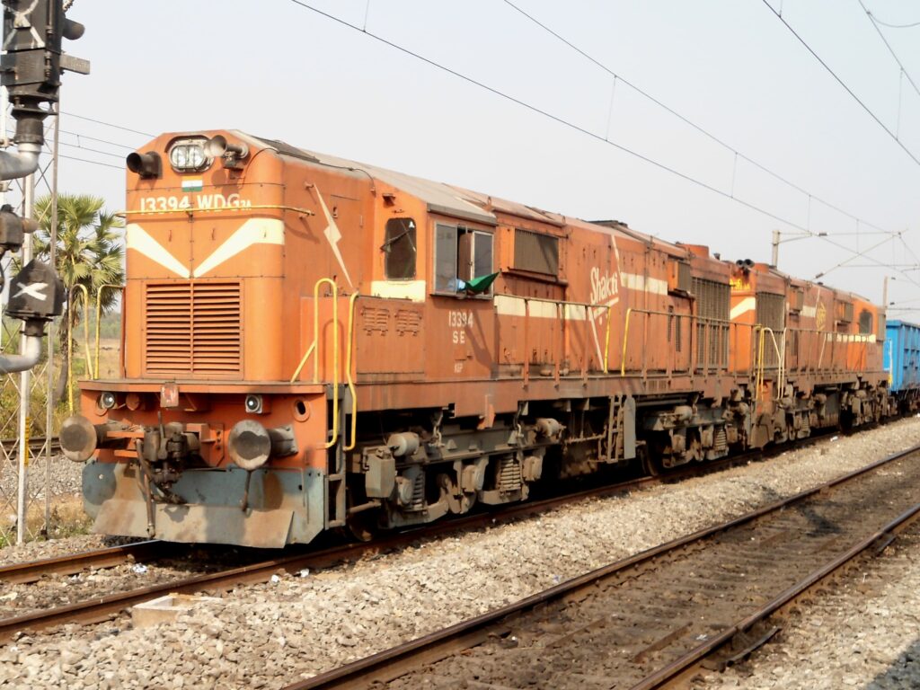 Indian Railways WDG3A diesel freight locomotive hauling goods train on railway track