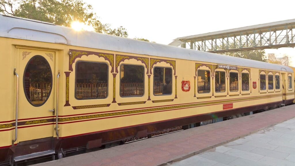 Palace on Wheels luxury train coach with royal Rajasthani design standing at station platform