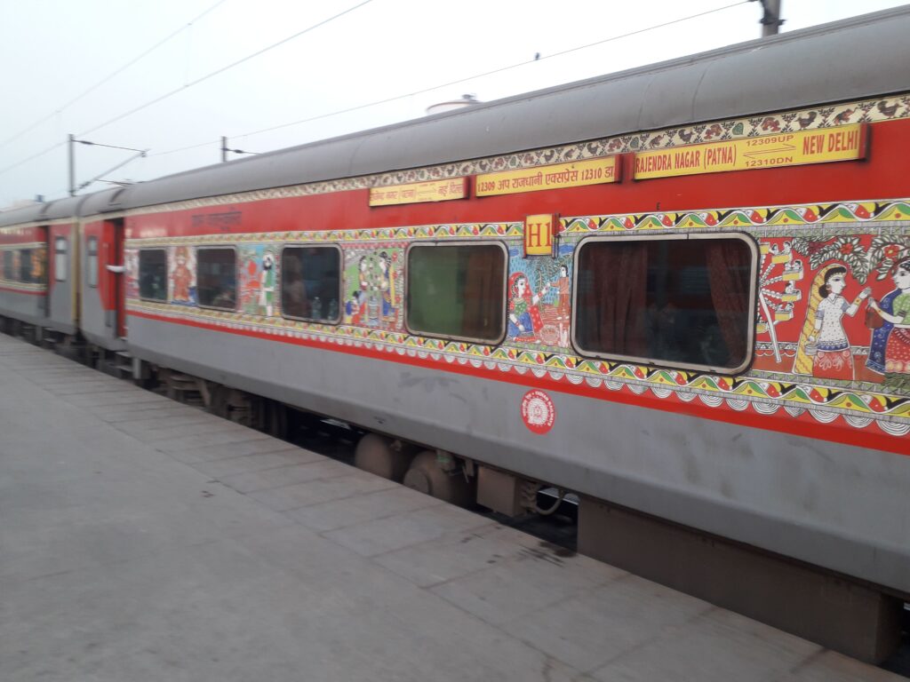 Rajdhani Express train coach with traditional artwork on Patna to New Delhi route at Indian railway station