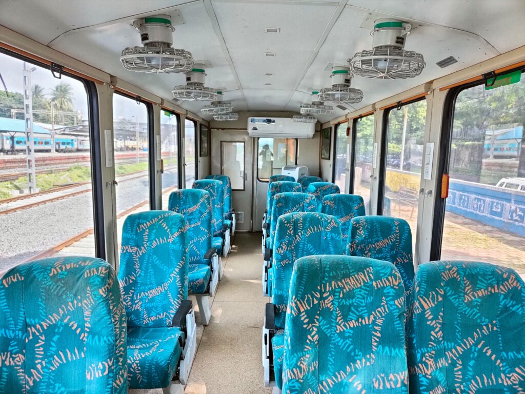 Vistadome train coach interior with large glass windows and comfortable seating arrangement