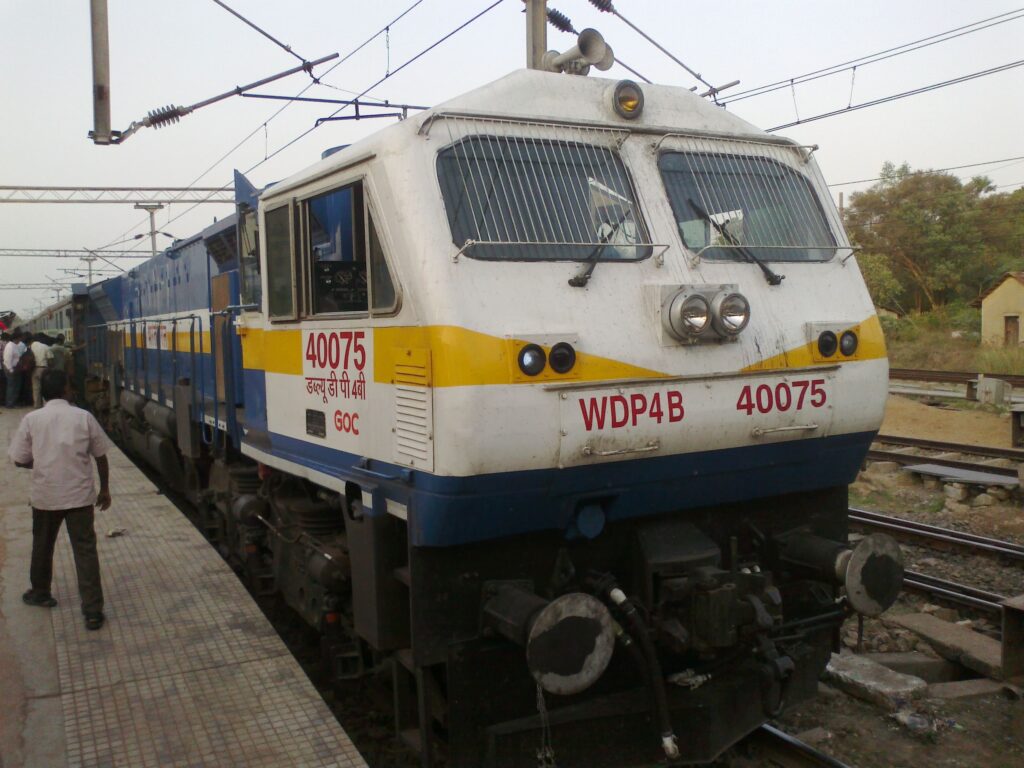 Indian Railways WDP4B diesel locomotive at railway platform with passenger train